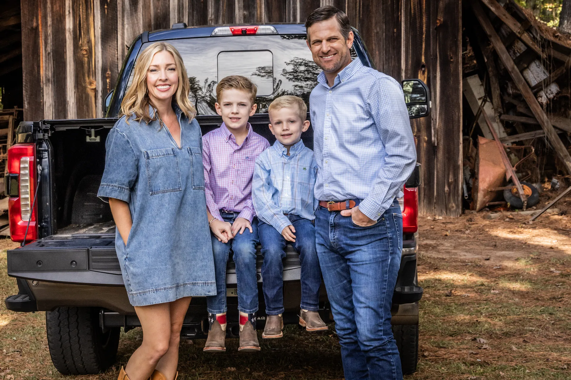 Brian Strickland with his wife and sons at the tailgate of the family truck